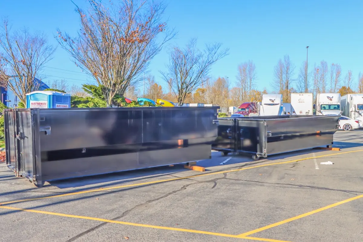 Professional dumpster rental service with roll-off container on residential driveway in Port Arthur